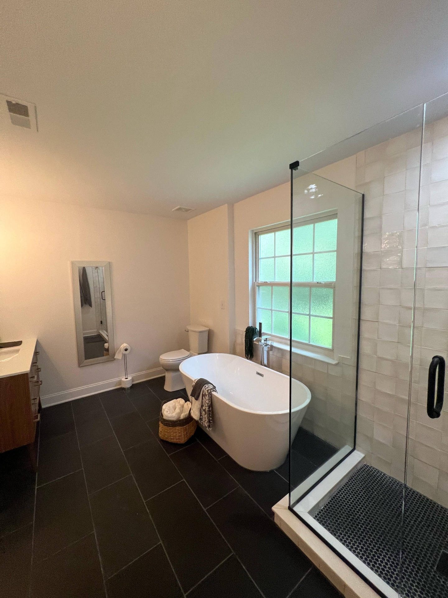 Master bathroom remodel with soaking tub and modern tile