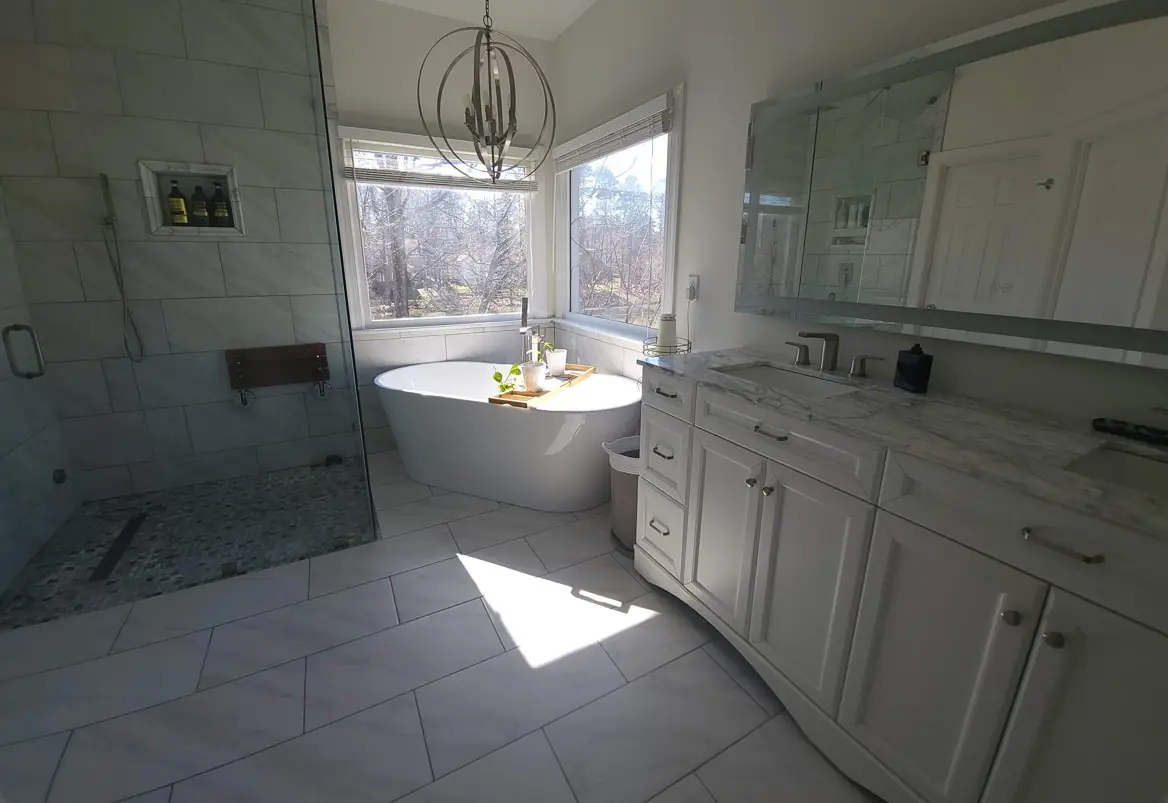 Luxury bathroom renovation with freestanding tub and glass shower enclosure