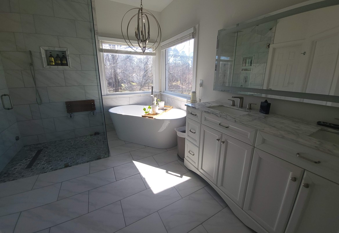 Luxury bathroom renovation with freestanding tub and glass shower enclosure