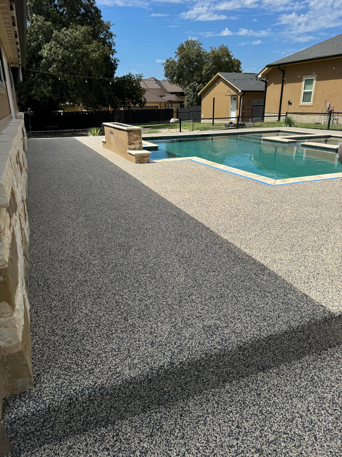 Pool deck with Vuba Stone aggregate finish around pool