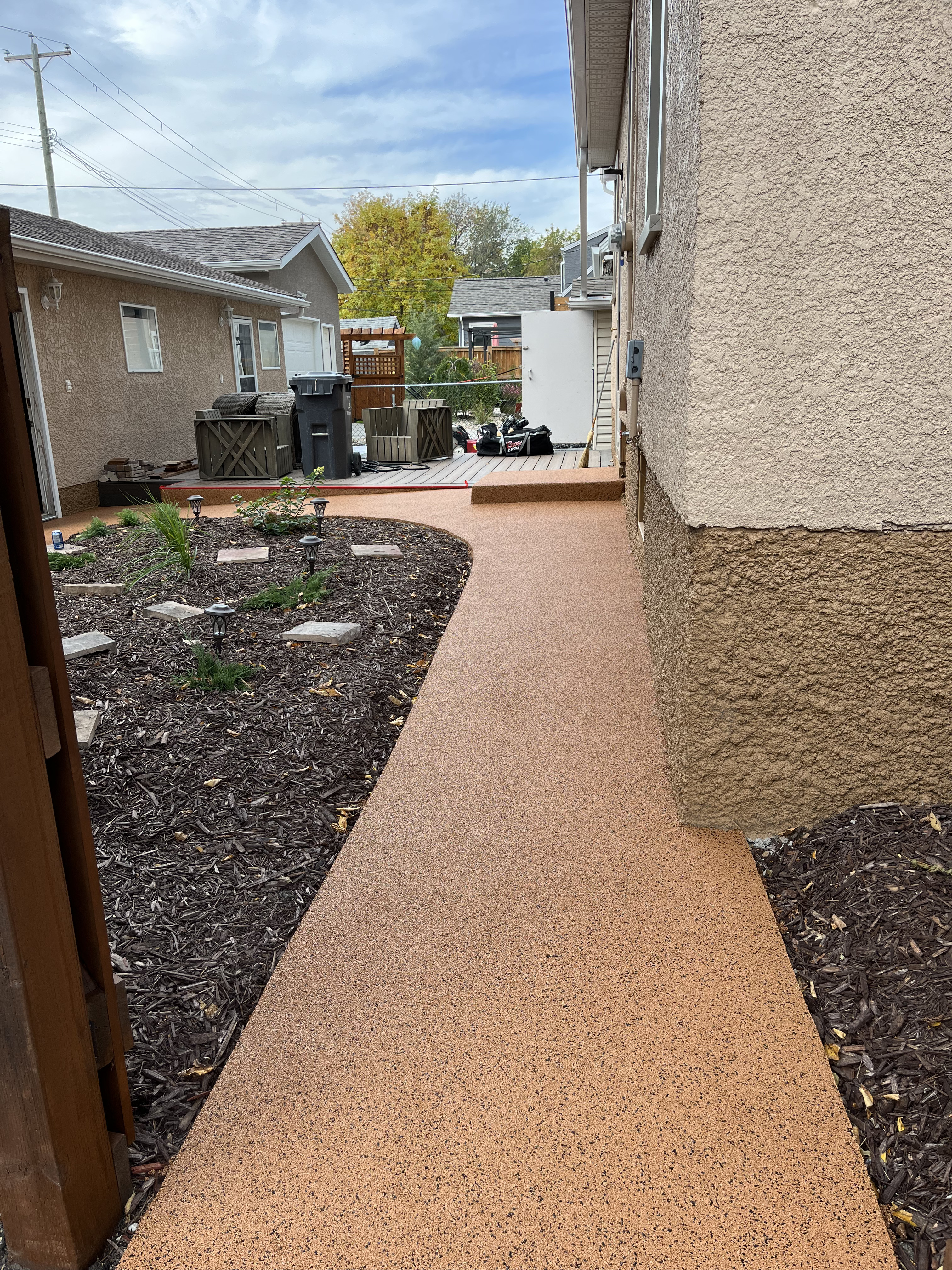 Backyard walkway through landscaping